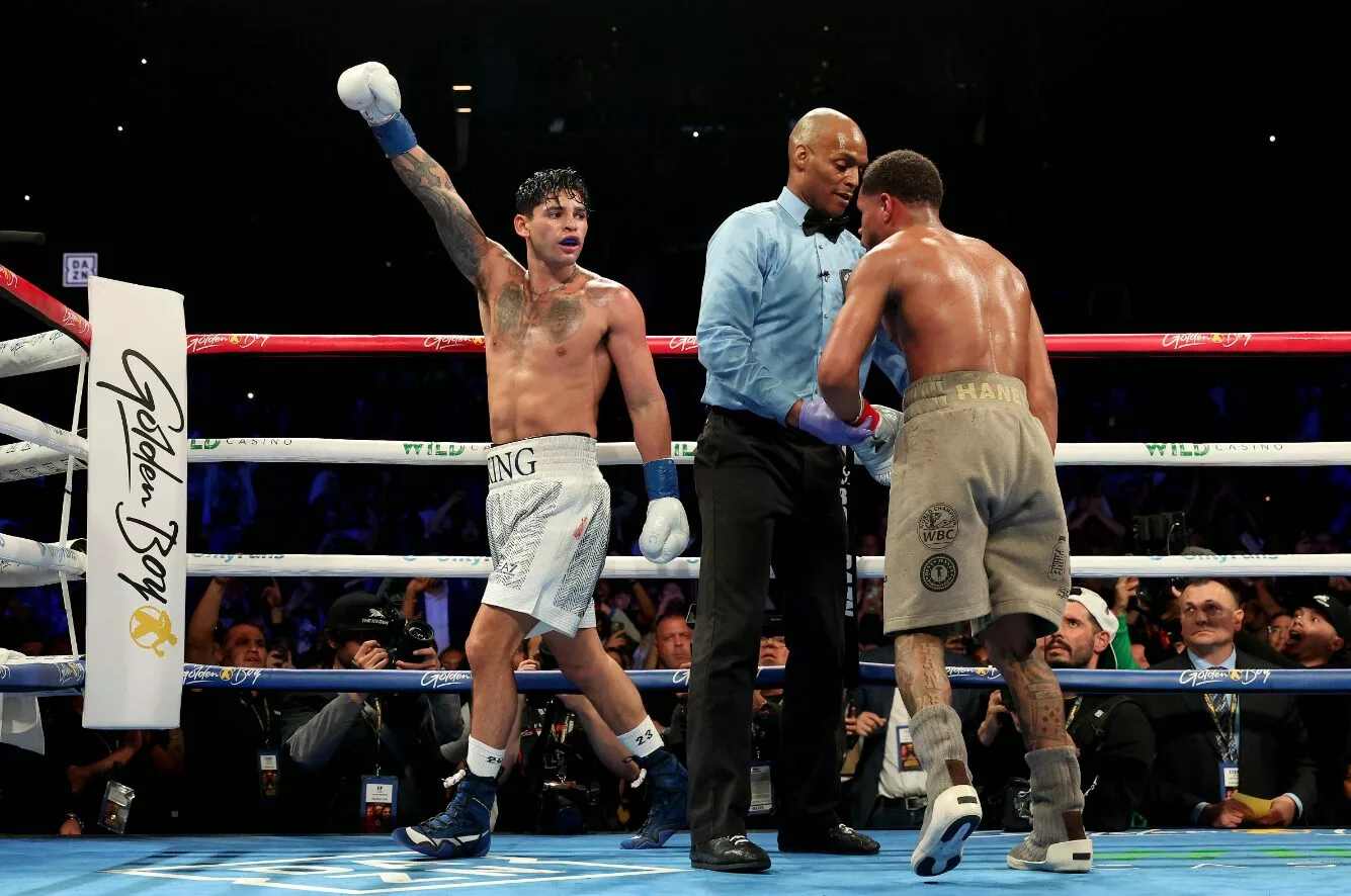 Ryan Garcia raises his arm in victory after his fight with Devin Haney.